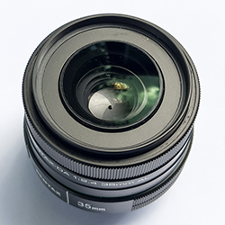 A close up of a camera lens, with a focus on the iris.